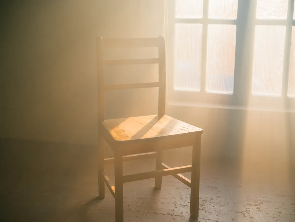 A serene moment of transition with soft ambient lighting and minimal surroundings suggesting peace